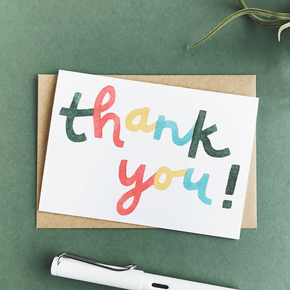 Card with &quot;thank you!&quot; in a playful font with green, red, yellow and blue letters.